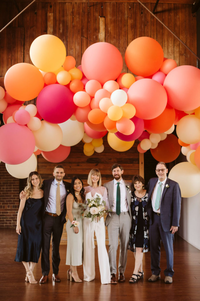 Modern industrial wedding ceremony at the Turnbull Building in Chattanooga with colorful balloon installation. Photo by OkCrowe Photography.