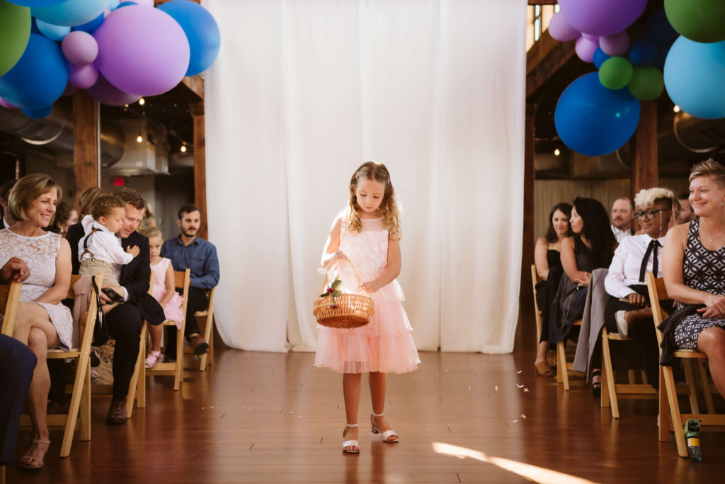 Modern industrial wedding ceremony at the Turnbull Building in Chattanooga with colorful balloon installation. Photo by OkCrowe Photography.