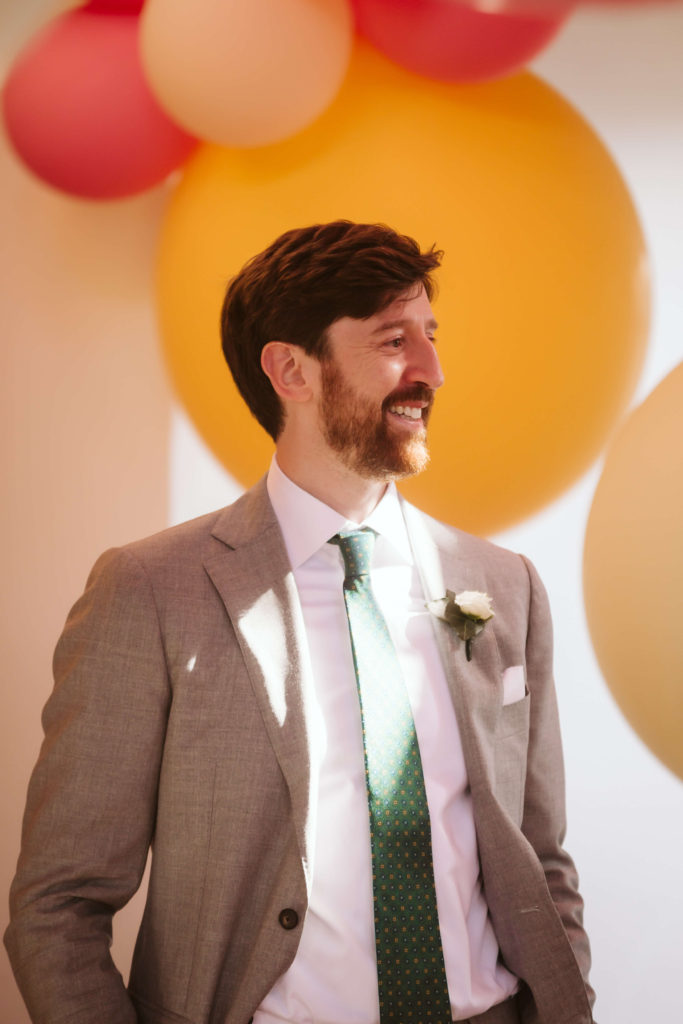 Modern industrial wedding ceremony at the Turnbull Building in Chattanooga with colorful balloon installation. Photo by OkCrowe Photography.