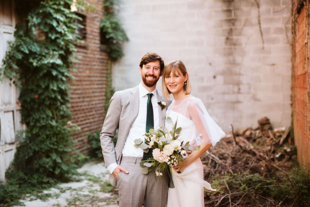 Newlywed portraits behind the Turnbull Building in Chattanooga. Photo by OkCrowe Photography.