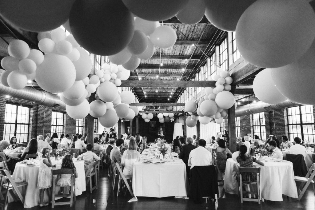 Modern industrial wedding reception at the Turnbull Building in Chattanooga with colorful balloon installation. Photo by OkCrowe Photography.