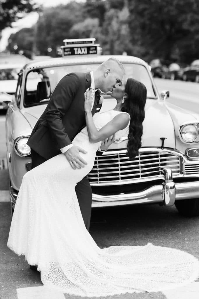 Bride and groom in front of NYC yellow taxi. Photo by OkCrowe Photography.