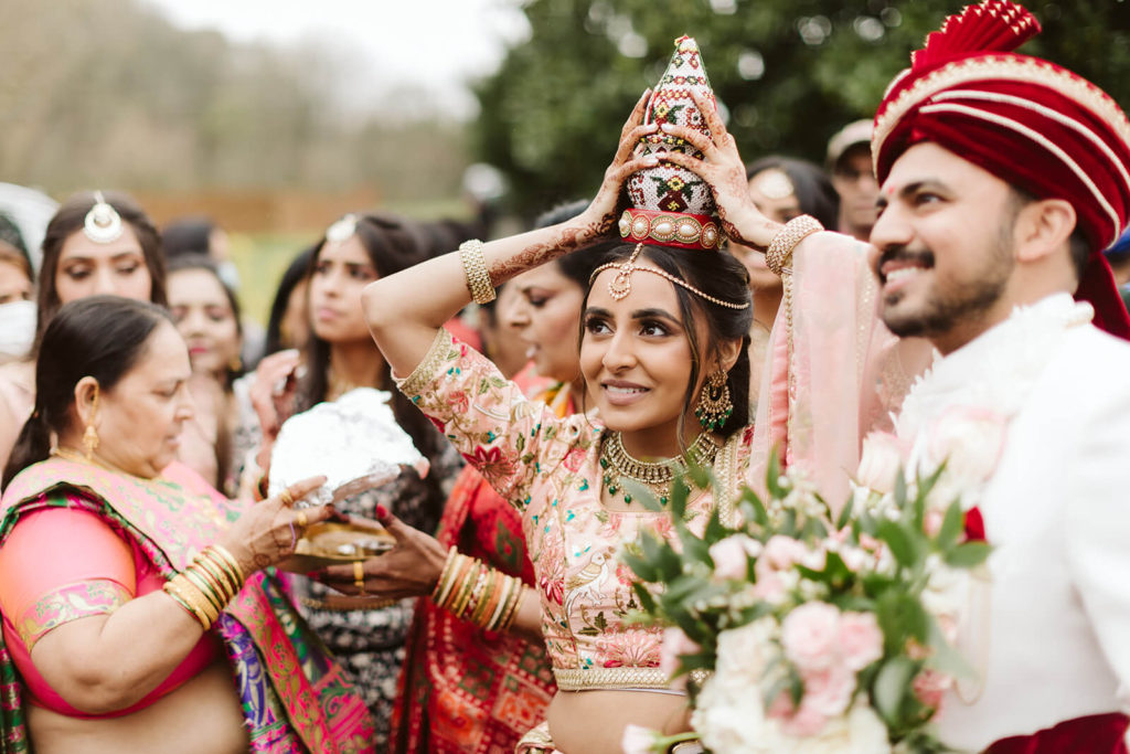 Indian groom arriving in a parade during baraat. Photo by OkCrowe Photography.