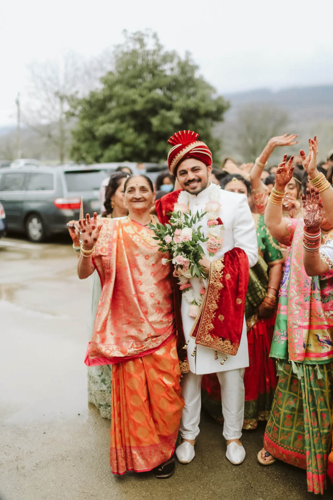 Indian groom with elder wedding guest. Photo by OkCrowe Photography.