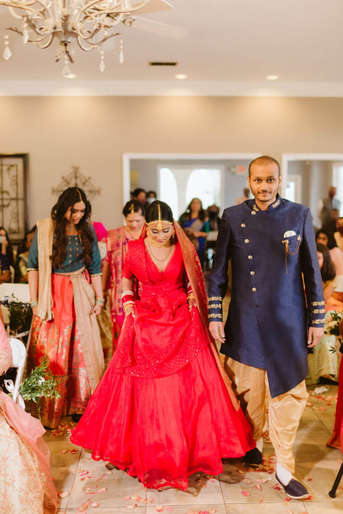 Indian bride being escorted by her father to her wedding ceremony. Photo by OkCrowe Photography.