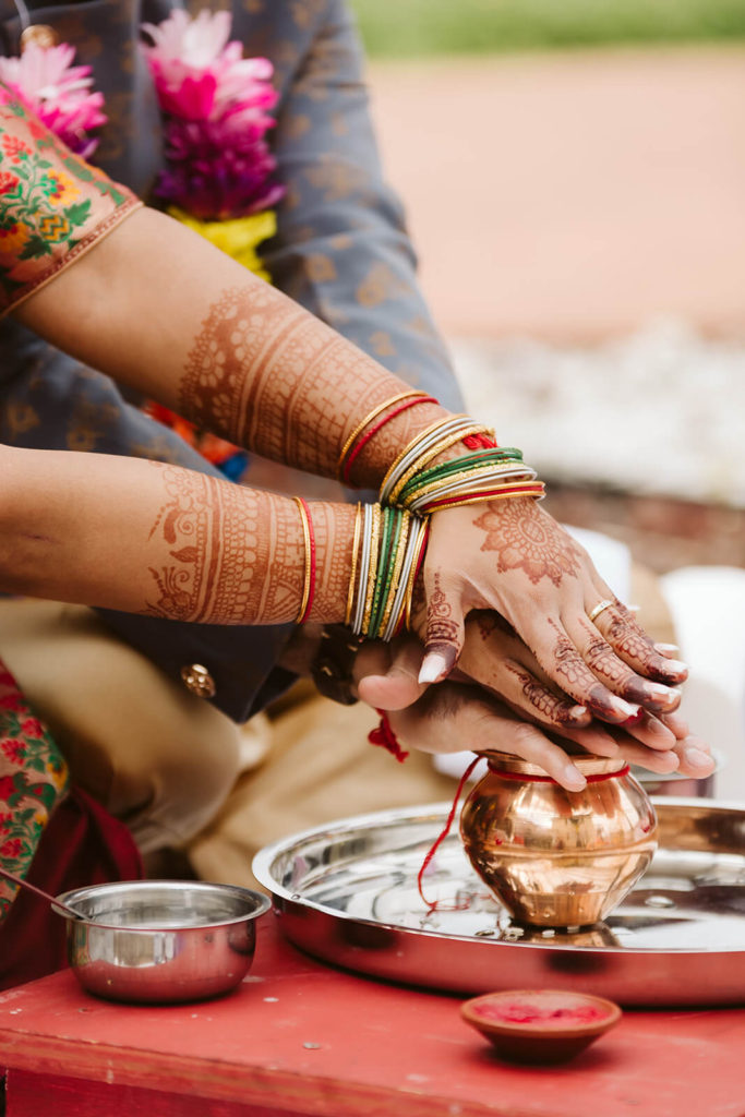 Performing a blessing during the Vidhi ceremony. Photo by OkCrowe Photography.