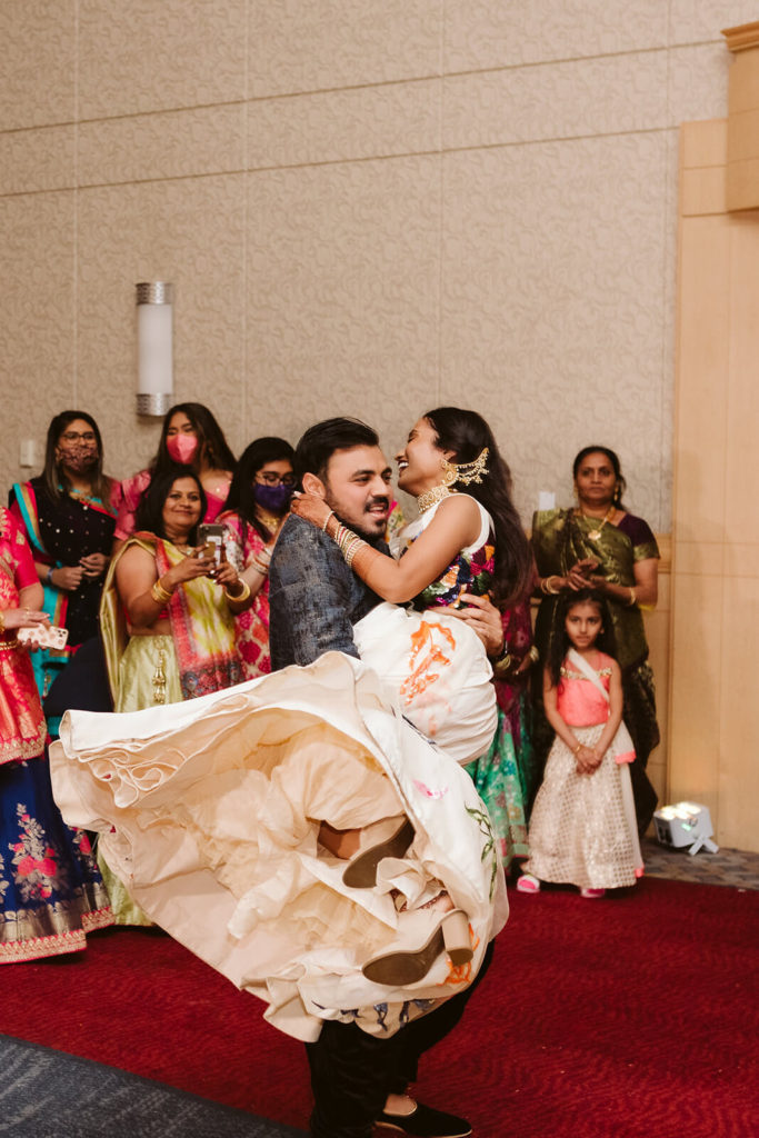 Bride and groom dancing during Sangeet. Photo by OkCrowe Photography.