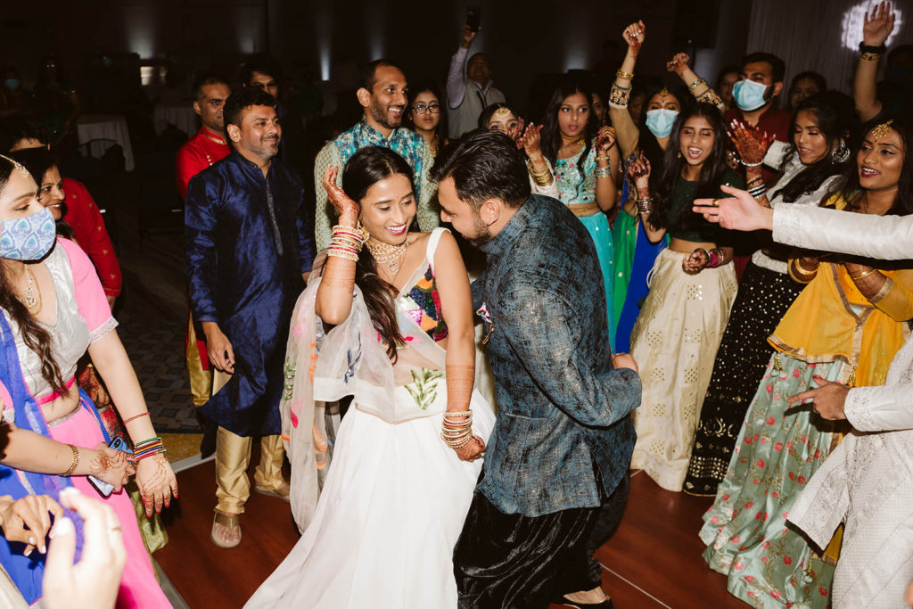 Bride and groom dancing during Sangeet. Photo by OkCrowe Photography.