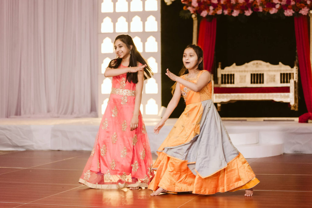 Young guests performing during Sangeet. Photo by OkCrowe Photography.