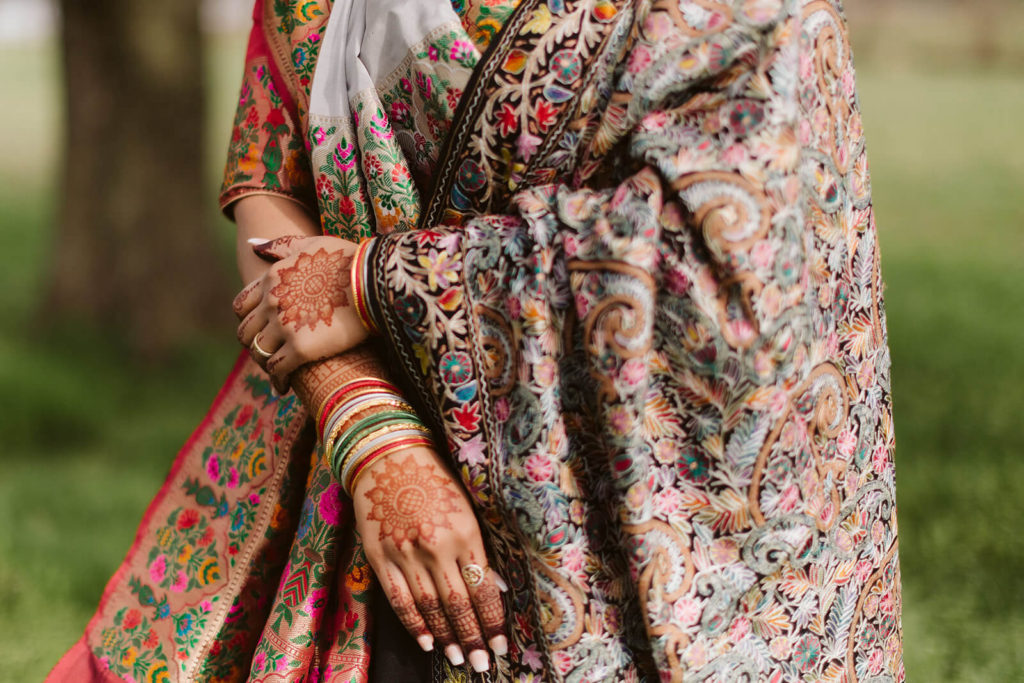 Bride wearing tradition South Asian wedding garments and jewelry. Photo by OkCrowe Photography.