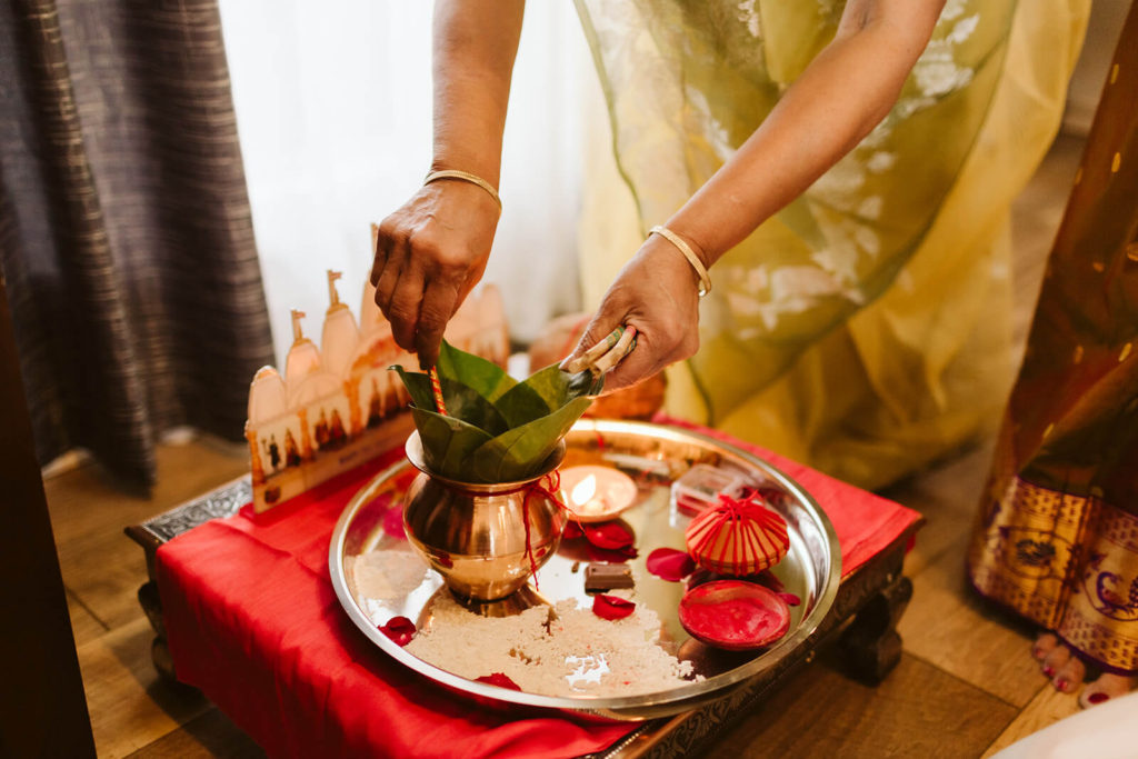 Preparing offerings during Pithi ceremony. Photo by OkCrowe Photography.