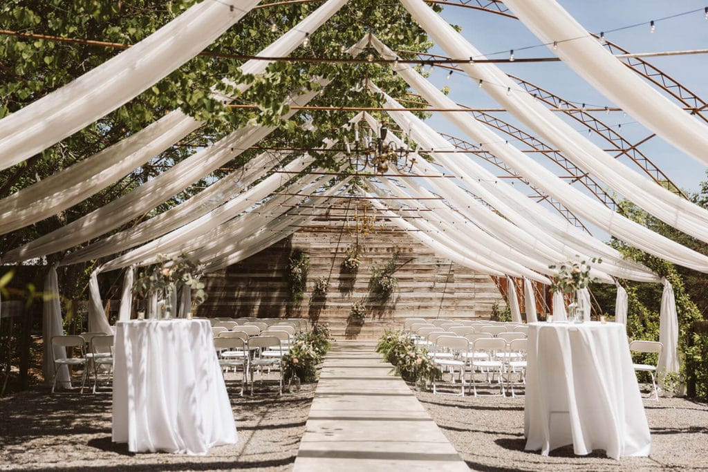 Garden wedding ceremony at the Venue at Lilly Lou's. Photo by OkCrowe Photography.