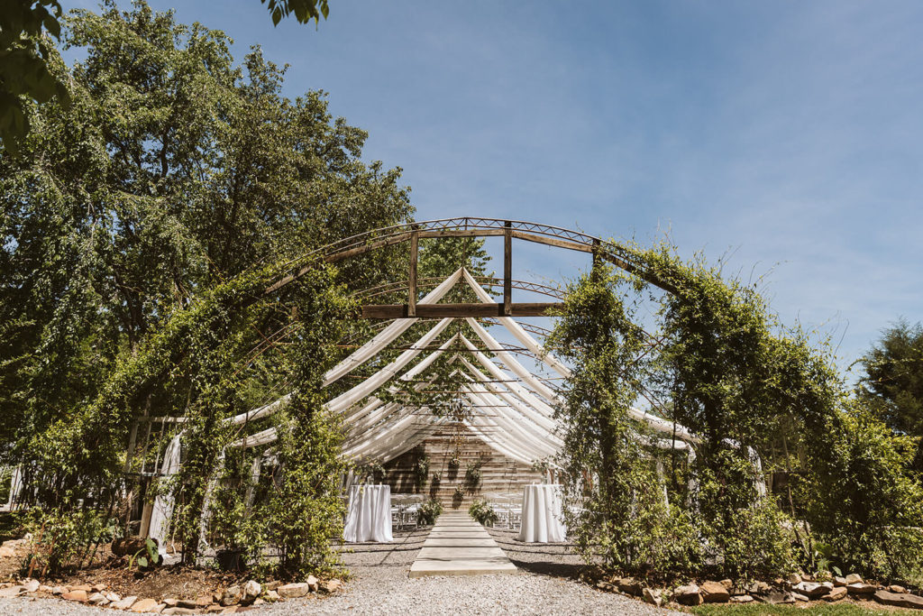 Garden wedding ceremony at the Venue at Lilly Lou's. Photo by OkCrowe Photography.