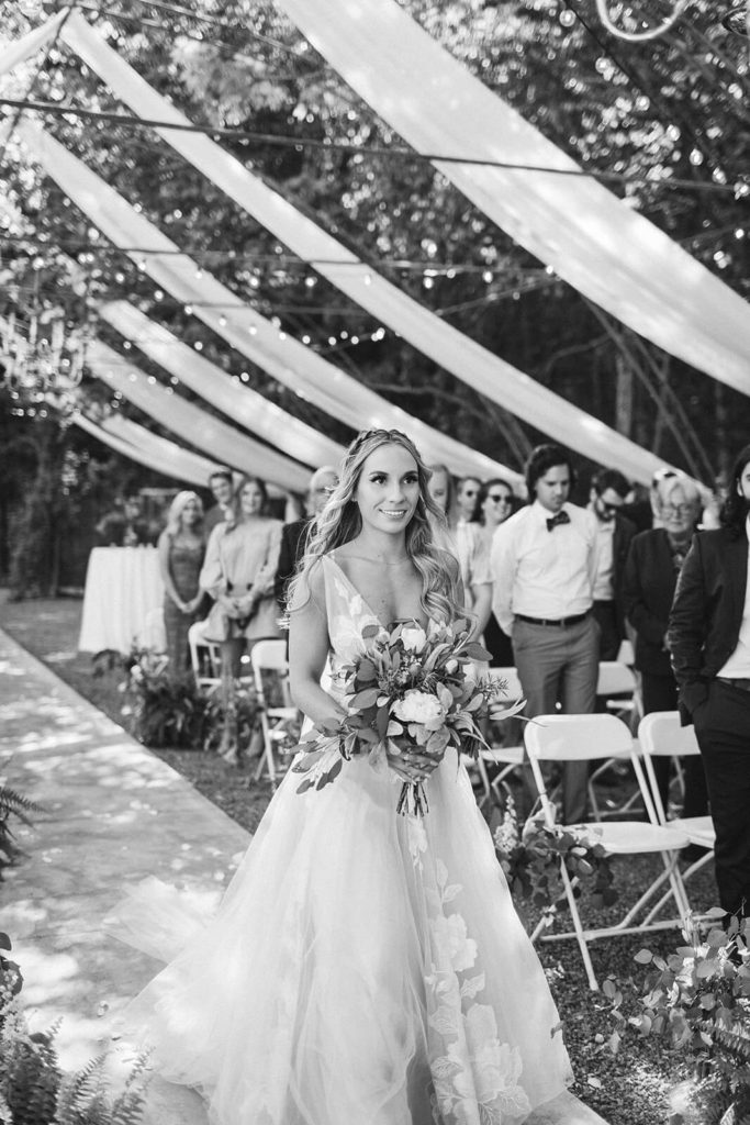 Garden wedding ceremony at the Venue at Lilly Lou's. Photo by OkCrowe Photography.