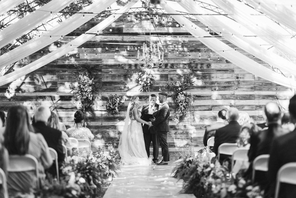 Garden wedding ceremony at the Venue at Lilly Lou's. Photo by OkCrowe Photography.