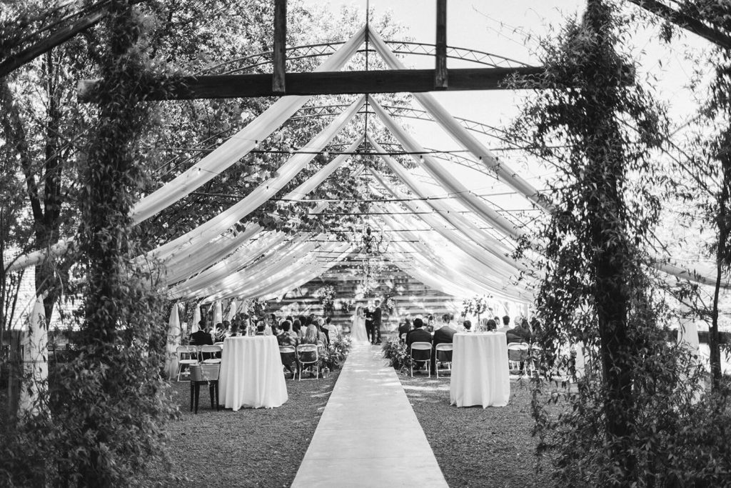 Garden wedding ceremony at the Venue at Lilly Lou's. Photo by OkCrowe Photography.