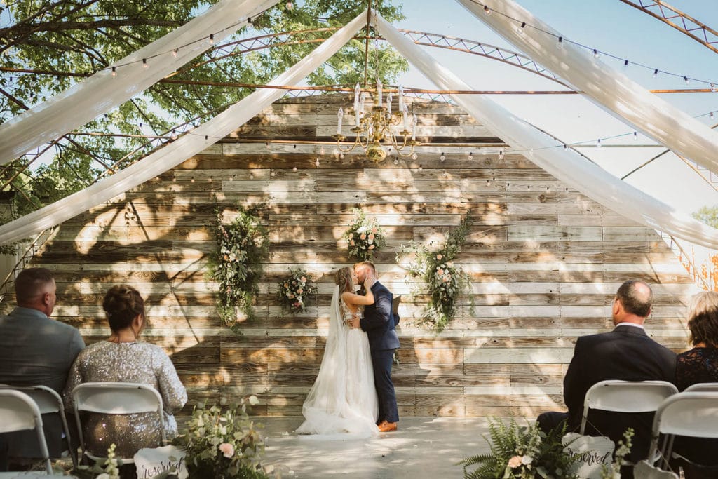 Garden wedding ceremony at the Venue at Lilly Lou's. Photo by OkCrowe Photography.