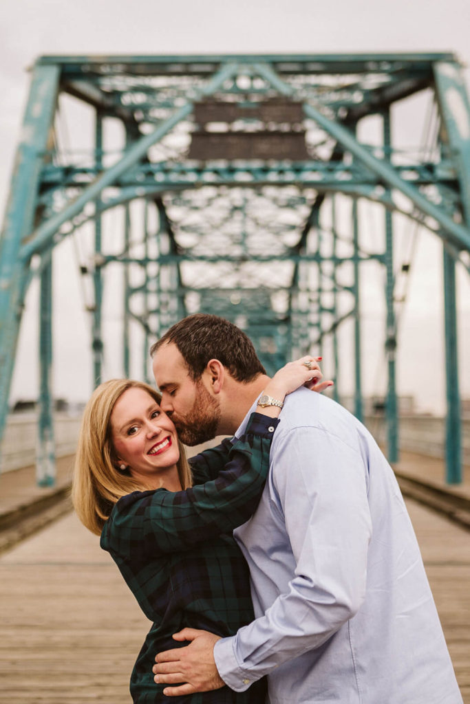 Engagement session on the Walnut St Bridge overlooking the river. Photo by OkCrowe Photography.