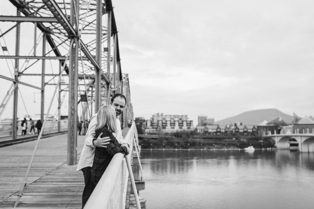 Engagement session on the Walnut St Bridge overlooking the river. Photo by OkCrowe Photography.