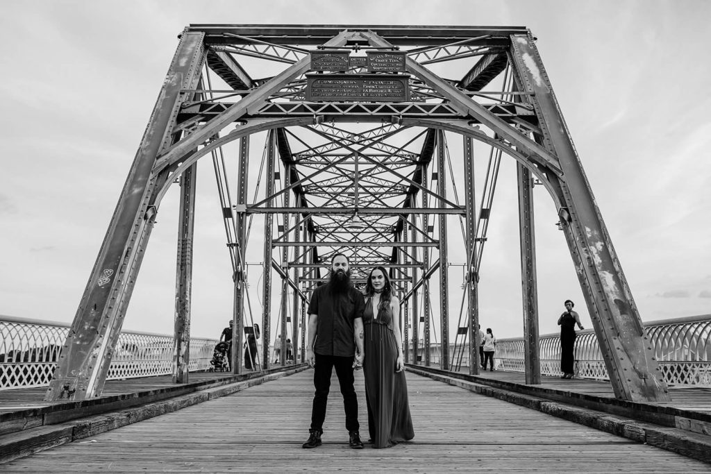 Engagement session on the Walnut St Bridge overlooking the river. Photo by OkCrowe Photography.