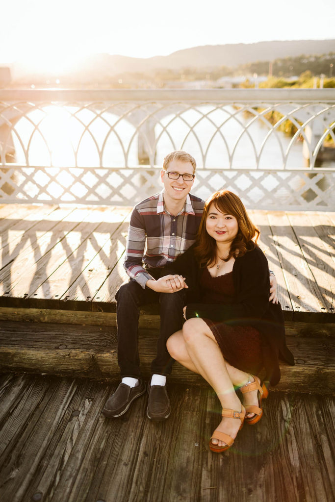 Engagement session on the Walnut St Bridge overlooking the river. Photo by OkCrowe Photography.