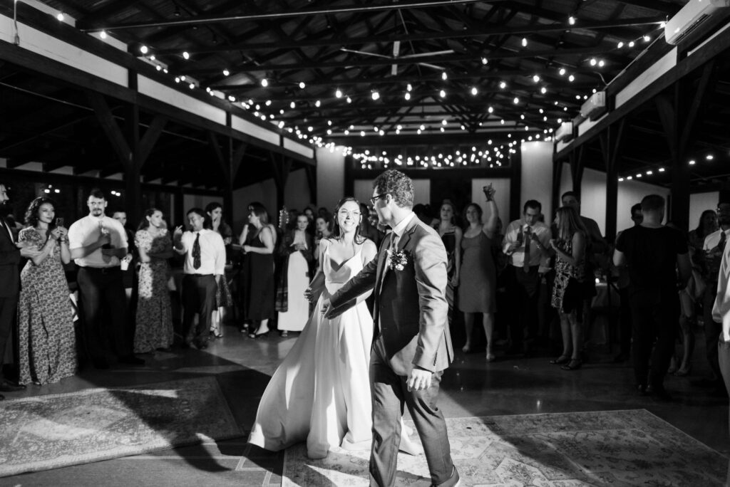 Wedding reception and dancing in the rain at the Hidden Springs Venue. Photo by OkCrowe Photography.