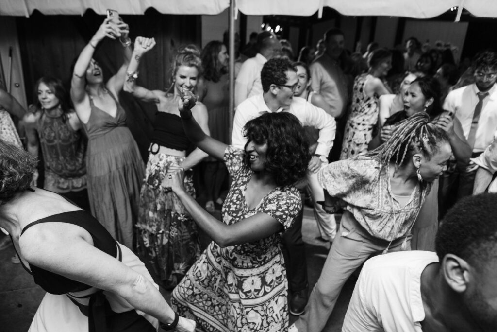 Wedding reception and dancing in the rain at the Hidden Springs Venue. Photo by OkCrowe Photography.