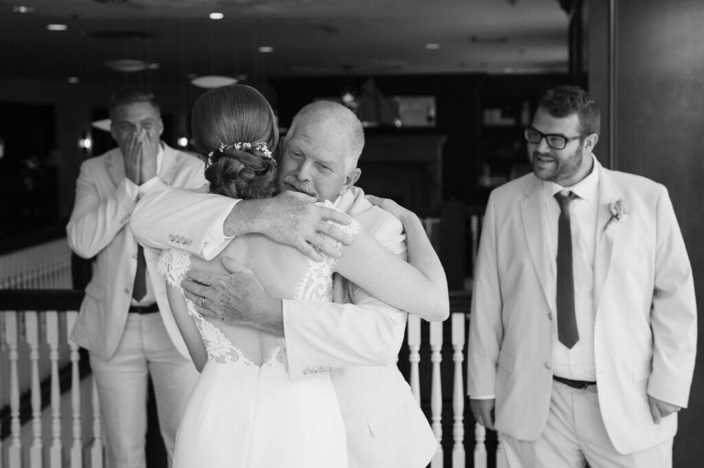 Bride's first look with her father and brothers at Portland Harbor Hotel. Photo by OkCrowe Photography.