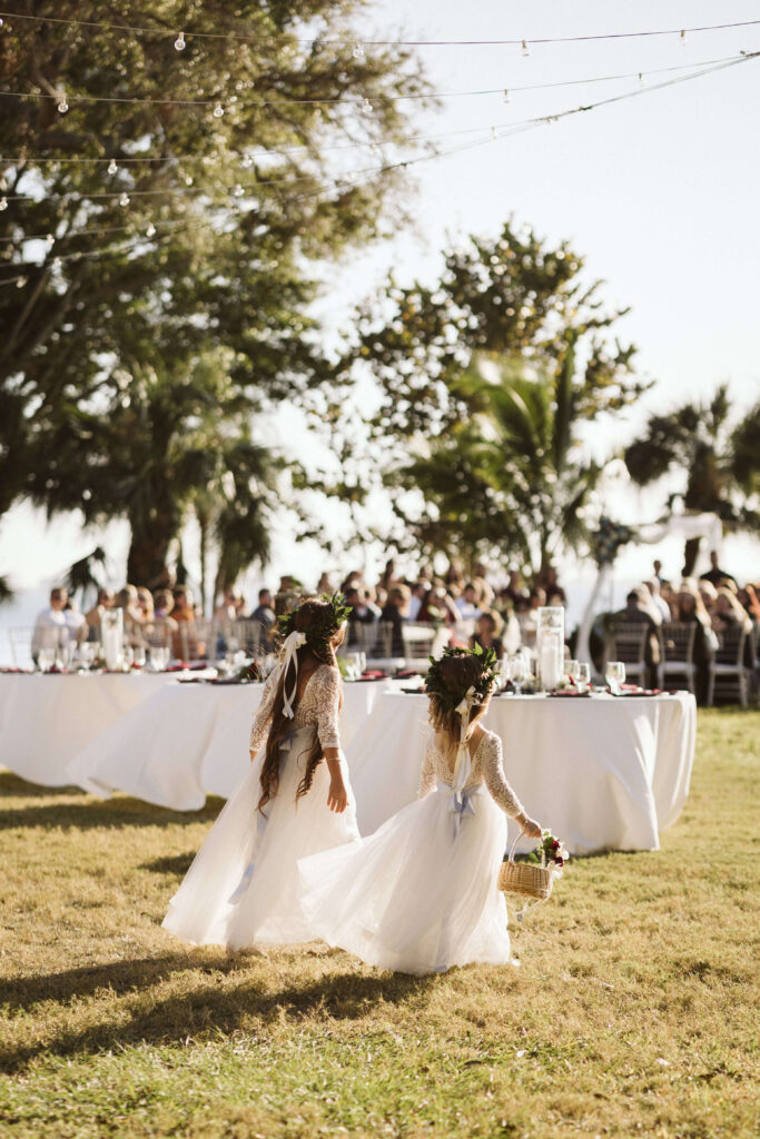 Beach themed wedding ceremony on the lawn at the Powel Crosley Estate in Sarasota, Florida. Photo by OkCrowe Photography.