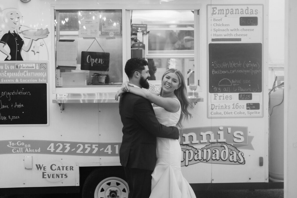 Newlywed portraits with a food truck in a North Georgia wedding venue. Photo by OkCrowe Photography. 