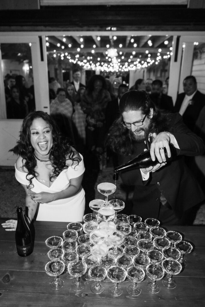 Champagne tower toast during a wedding reception at Oakleaf Cottage. Photo by OkCrowe Photography. 