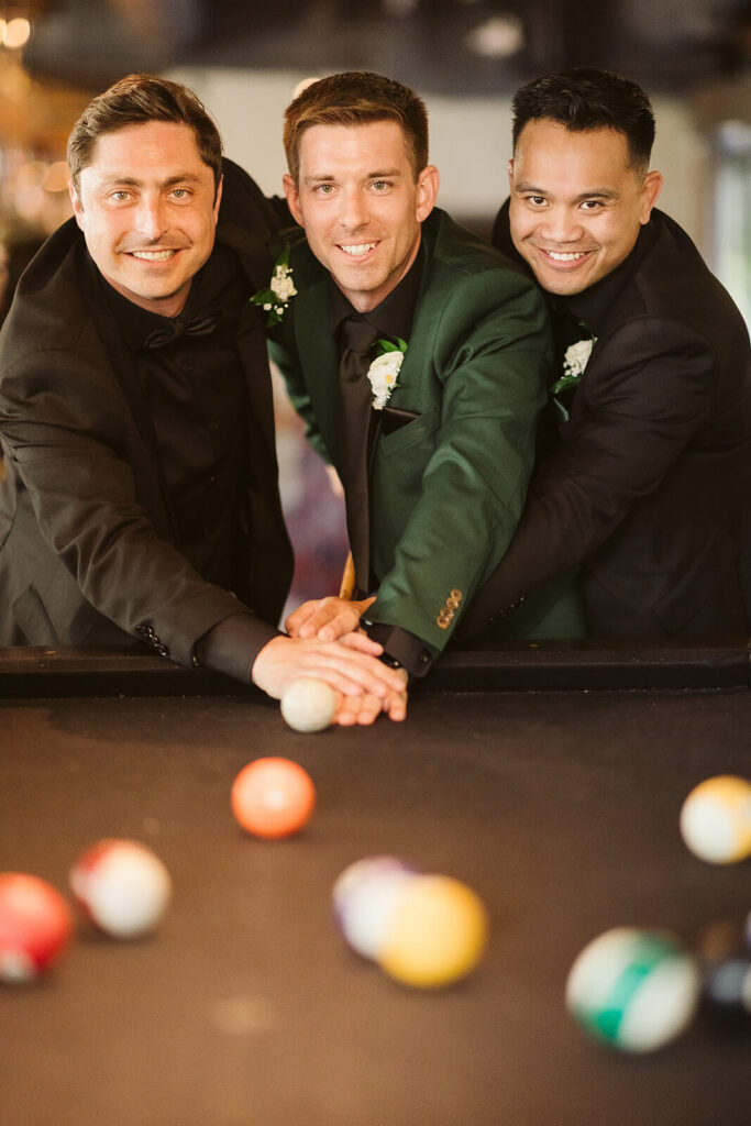 Groom and groomsmen playing pool at the Moxy Chattanooga before the wedding ceremony. Photo by OkCrowe Photography.