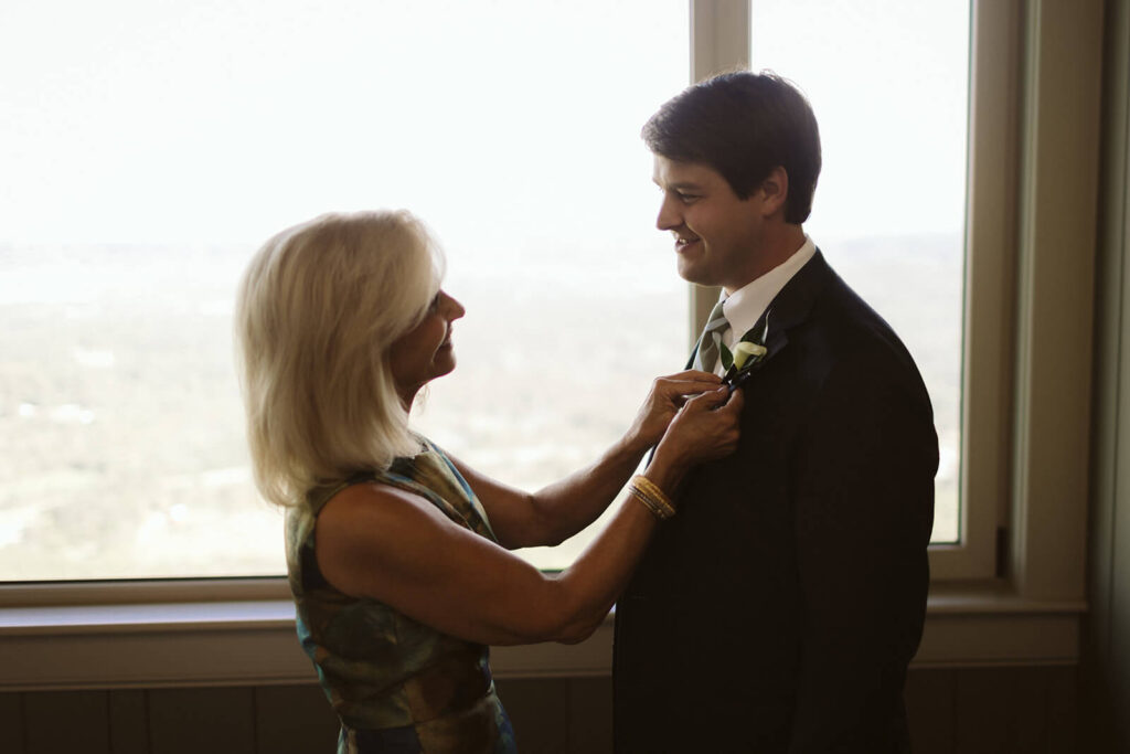 Mother helping her son get ready for his wedding at the Lookout Mountain Fairyland Clubhouse. Photo by OkCrowe Photography. 