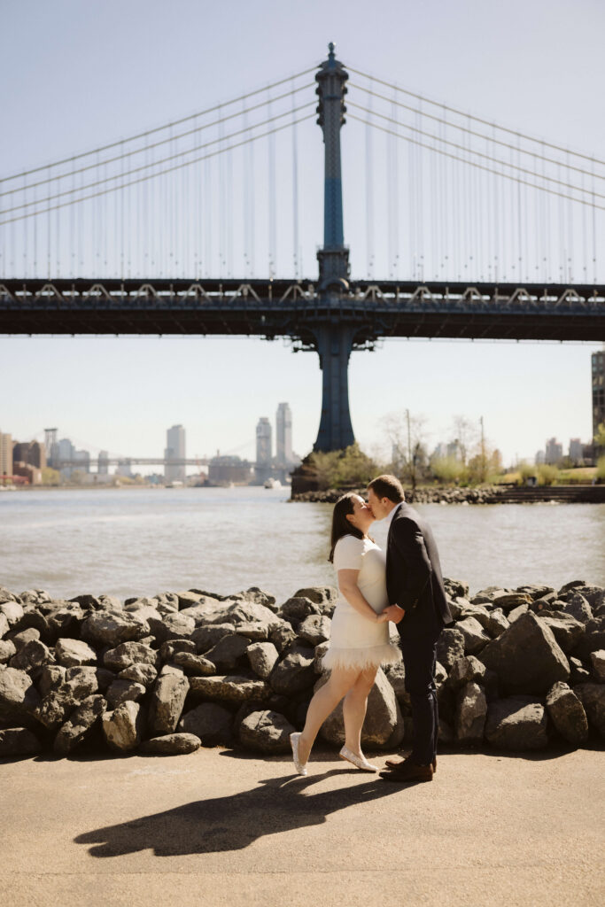 Engagement session with the Manhattan skyline in Brooklyn Bridge Park in DUMBO Brooklyn, NYC. Photo by OkCrowe Photography. 