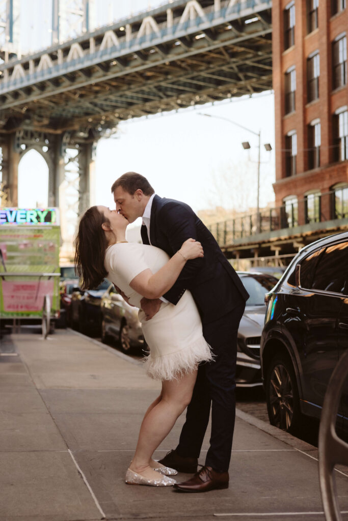 Engagement session on Washington Street between Water and Front Street with the Manhattan Bridge in DUMBO Brooklyn, NYC. Photo by OkCrowe Photography. 