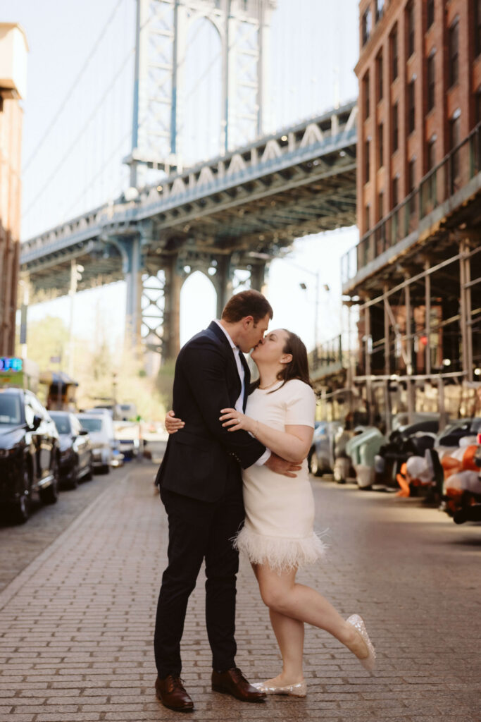 Engagement session on Washington Street between Water and Front Street with the Manhattan Bridge in DUMBO Brooklyn, NYC. Photo by OkCrowe Photography. 