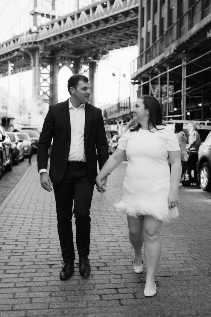 Engagement session on Washington Street between Water and Front Street with the Manhattan Bridge in DUMBO Brooklyn, NYC. Photo by OkCrowe Photography. 