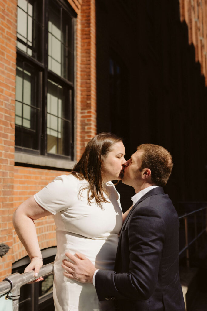 Engagement session on Washington Street between Water and Front Street with the Manhattan Bridge in DUMBO Brooklyn, NYC. Photo by OkCrowe Photography. 