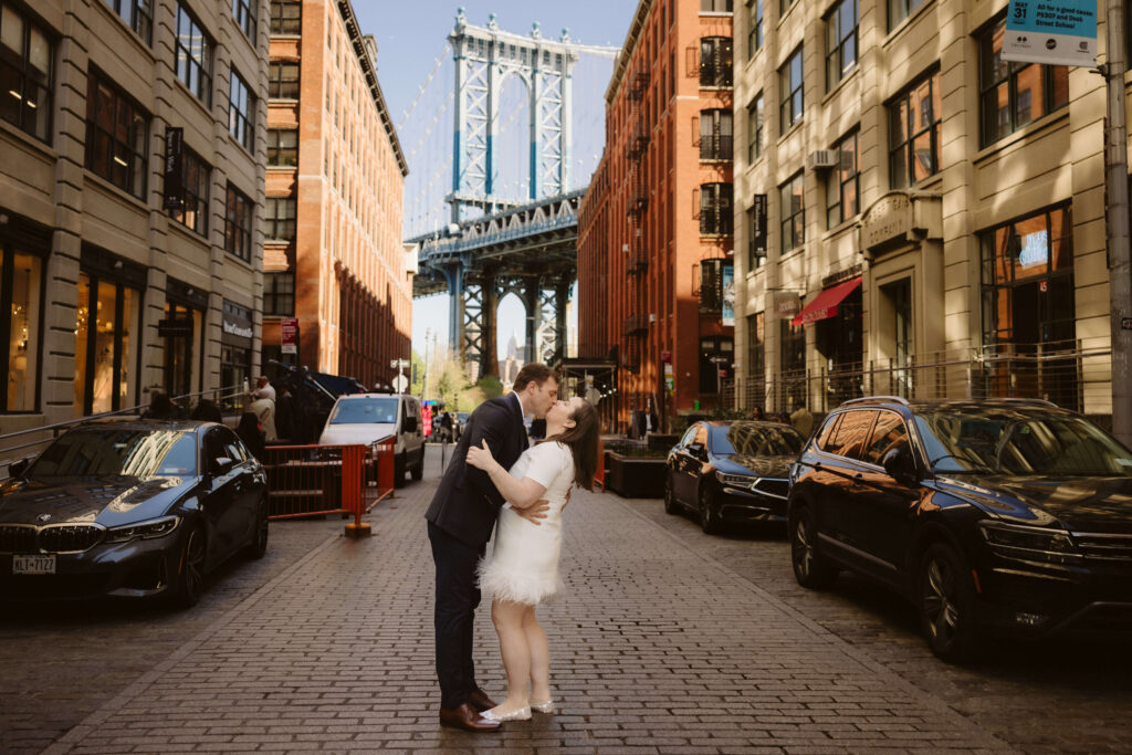 Engagement session on Washington Street between Water and Front Street with the Manhattan Bridge in DUMBO Brooklyn, NYC. Photo by OkCrowe Photography. 