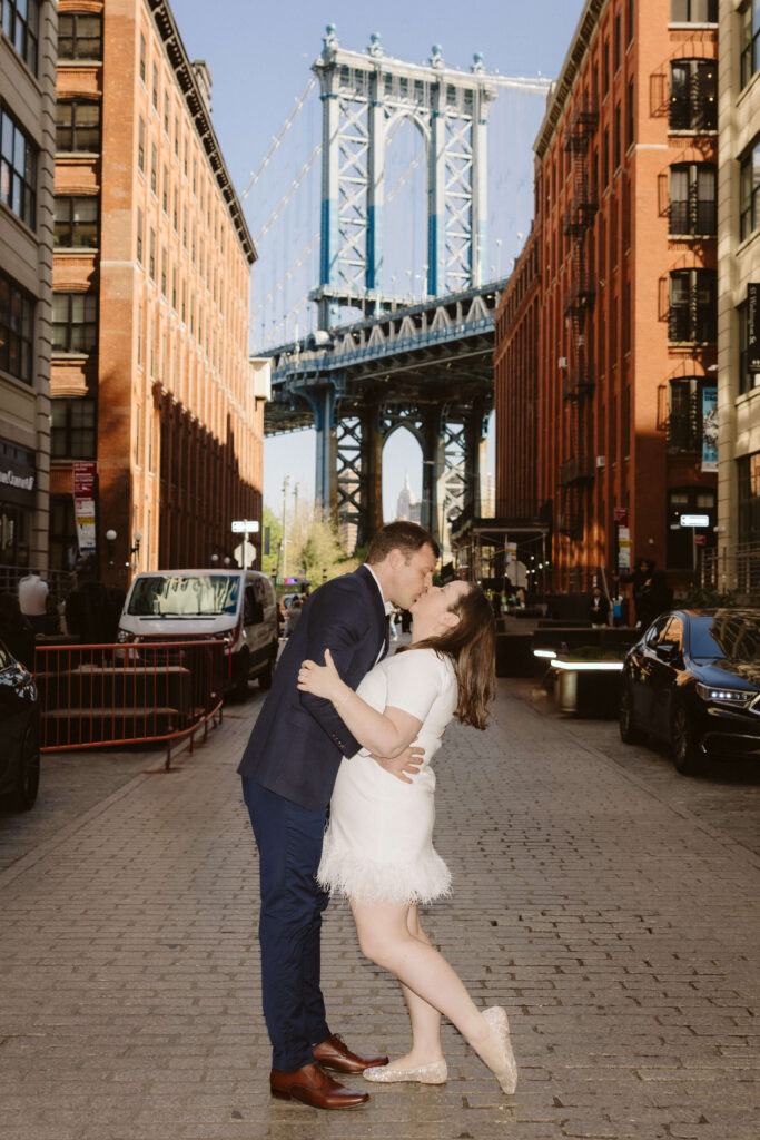 Engagement session on Washington Street between Water and Front Street with the Manhattan Bridge in DUMBO Brooklyn, NYC. Photo by OkCrowe Photography. 