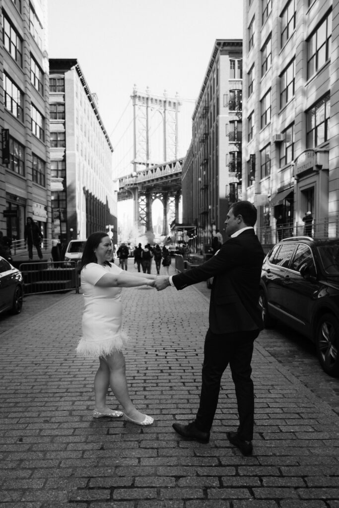 Engagement session on Washington Street between Water and Front Street with the Manhattan Bridge in DUMBO Brooklyn, NYC. Photo by OkCrowe Photography. 