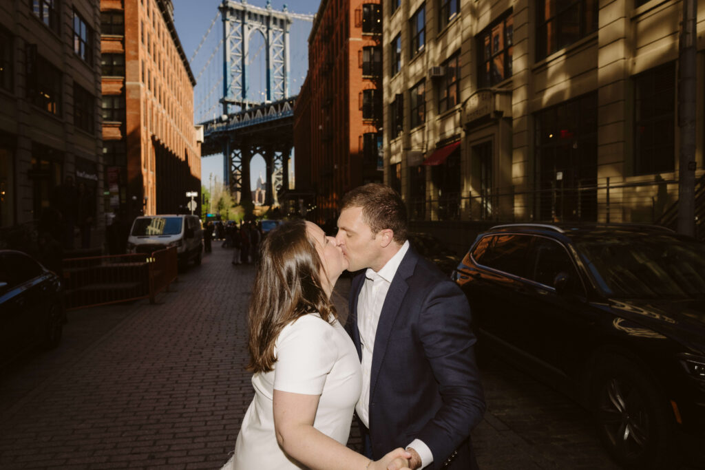 Engagement session on Washington Street between Water and Front Street with the Manhattan Bridge in DUMBO Brooklyn, NYC. Photo by OkCrowe Photography. 