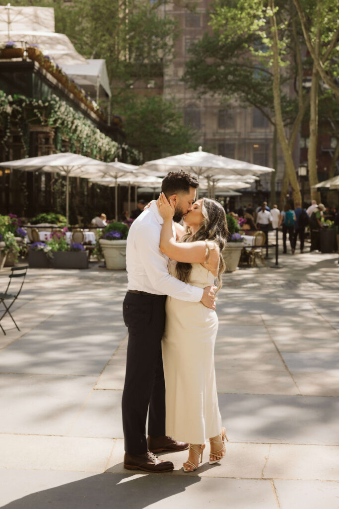 Spring engagement session by the Bryant Park Grill in Bryant Park, NYC. Photo by OkCrowe Photography.