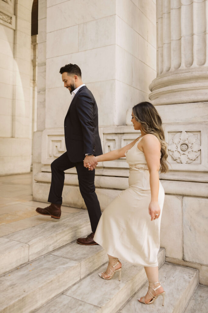 Spring engagement session outside the New York Public Library. Photo by OkCrowe Photography.