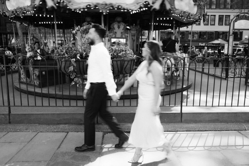 Spring engagement session by the carousel in Bryant Park, NYC. Photo by OkCrowe Photography.