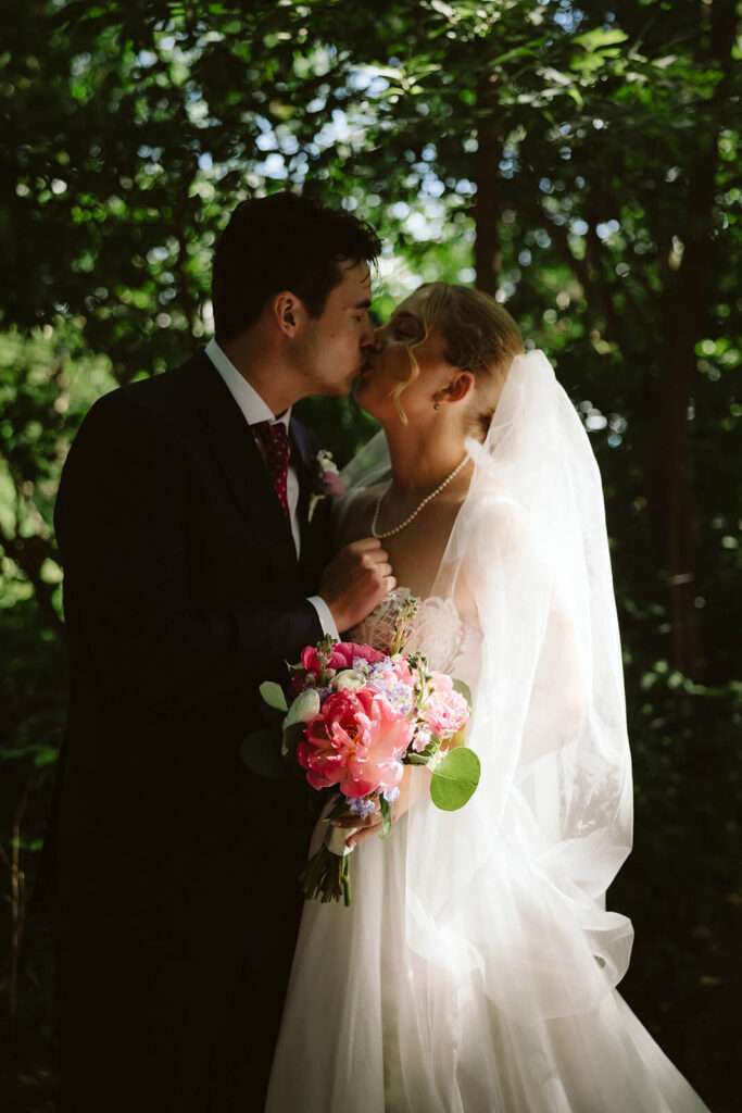 Bride and groom portraits along a  forested path in Brooklyn Bridge Park. Photo by OkCrowe Photography. 