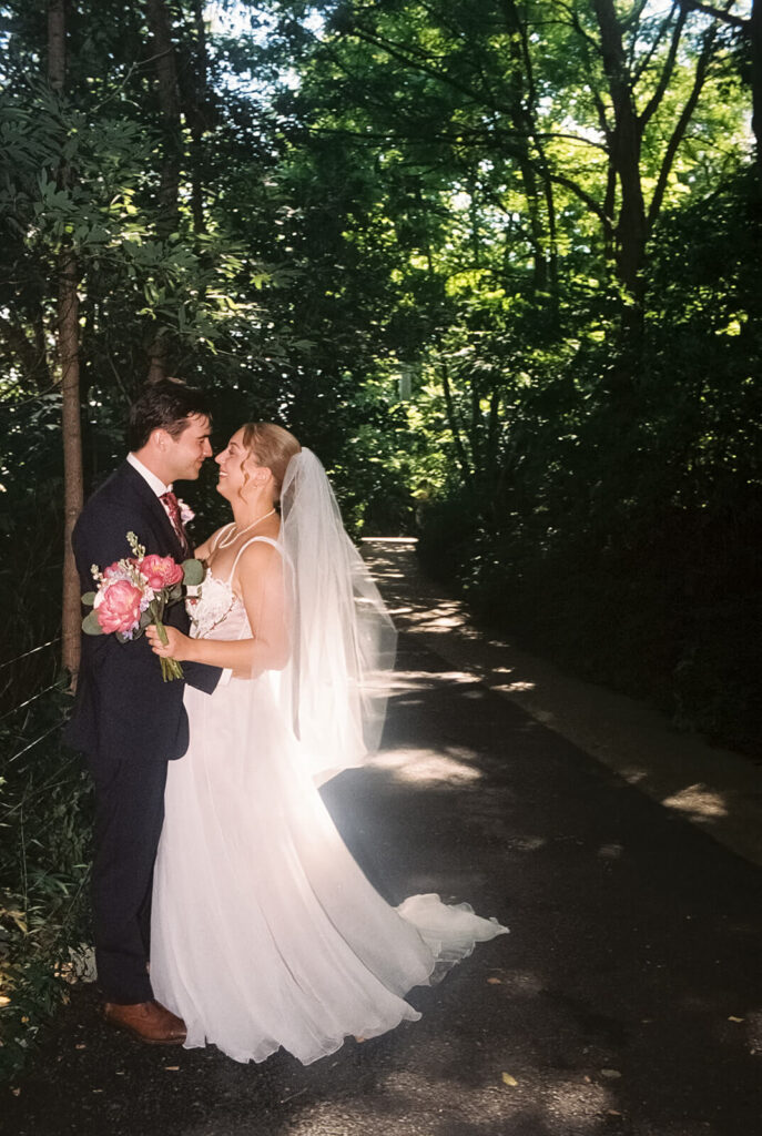 Bride and groom portraits along a  forested path in Brooklyn Bridge Park. Photo by OkCrowe Photography. 