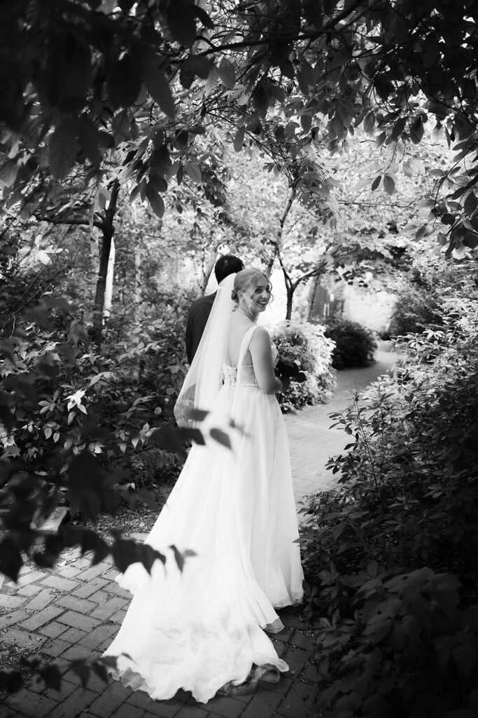 Bride and groom portraits along a  forested path in Brooklyn Bridge Park. Photo by OkCrowe Photography. 