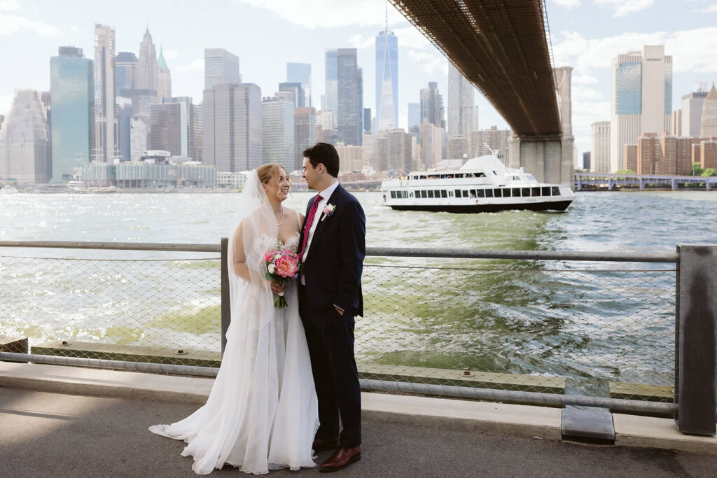 Bride and groom portraits along a  the waterfront in Brooklyn Bridge Park. Photo by OkCrowe Photography. 