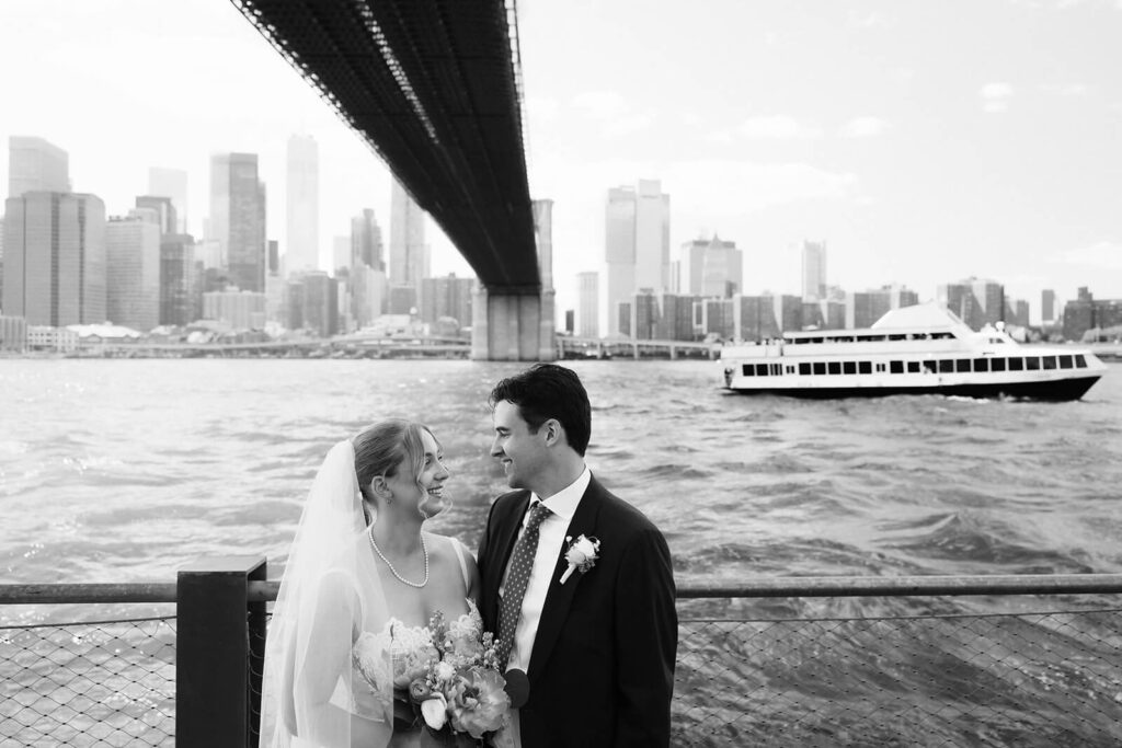 Bride and groom portraits along a  the waterfront in Brooklyn Bridge Park. Photo by OkCrowe Photography. 